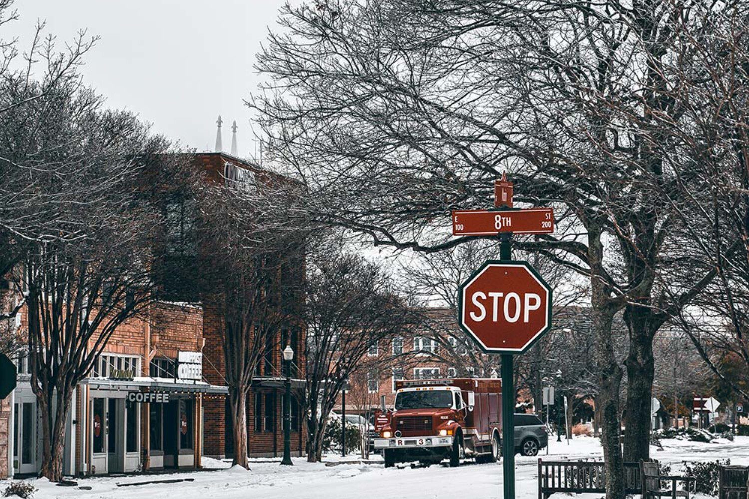 snowy town with a stop sign
