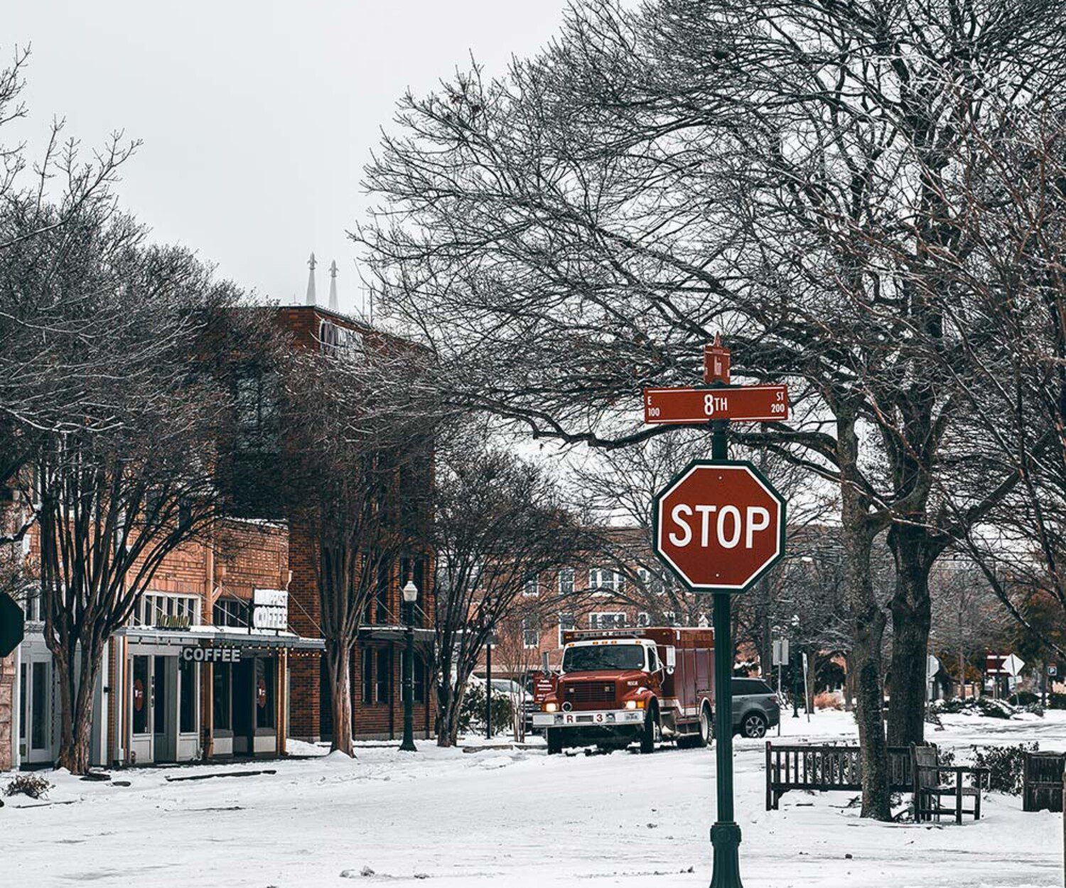 snowy town with a stop sign