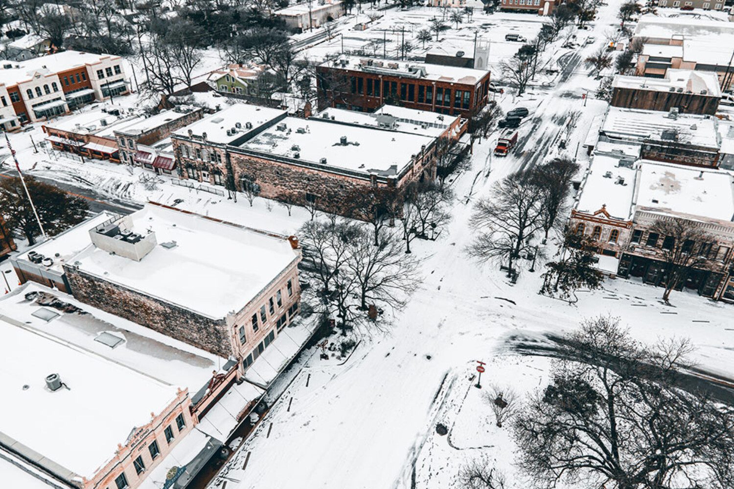 birds eye view of a town with snow on the ground