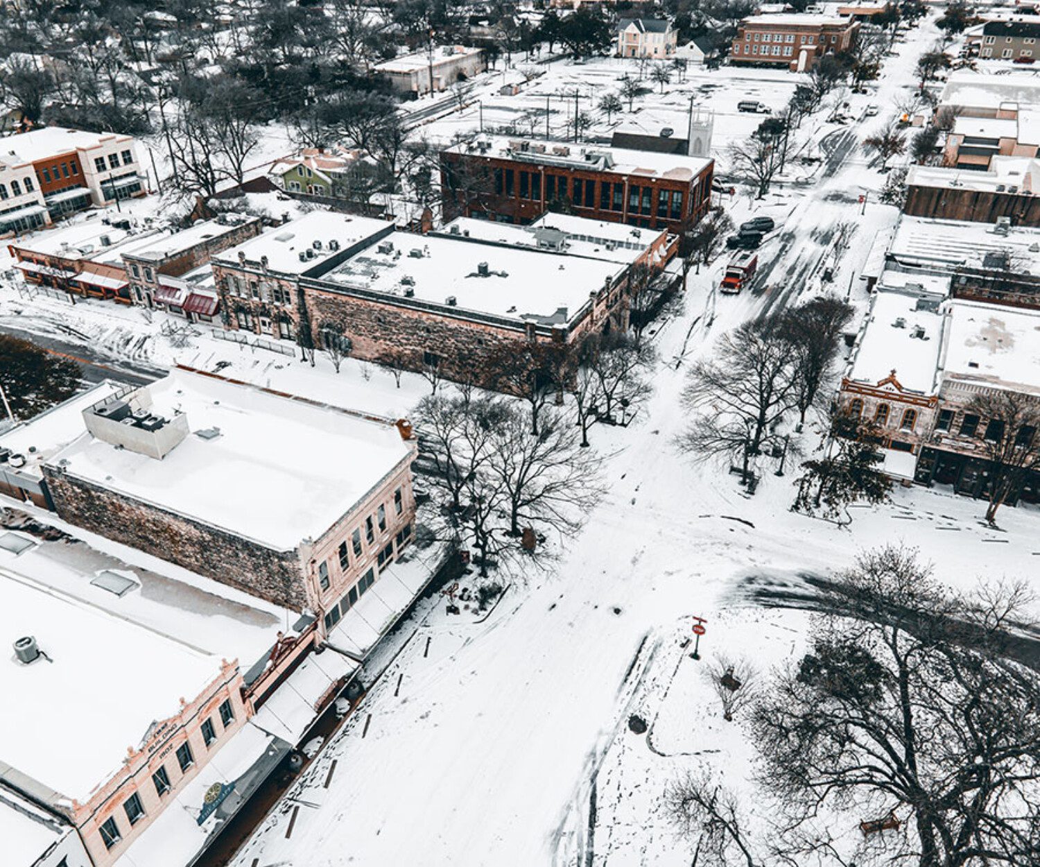 birds eye view of a town with snow on the ground