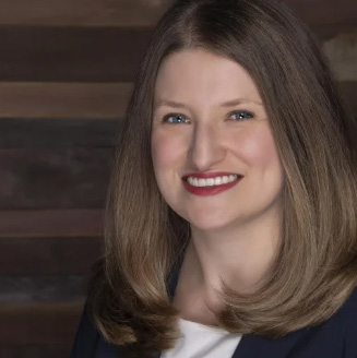 Headshot of a woman against a wooden background
