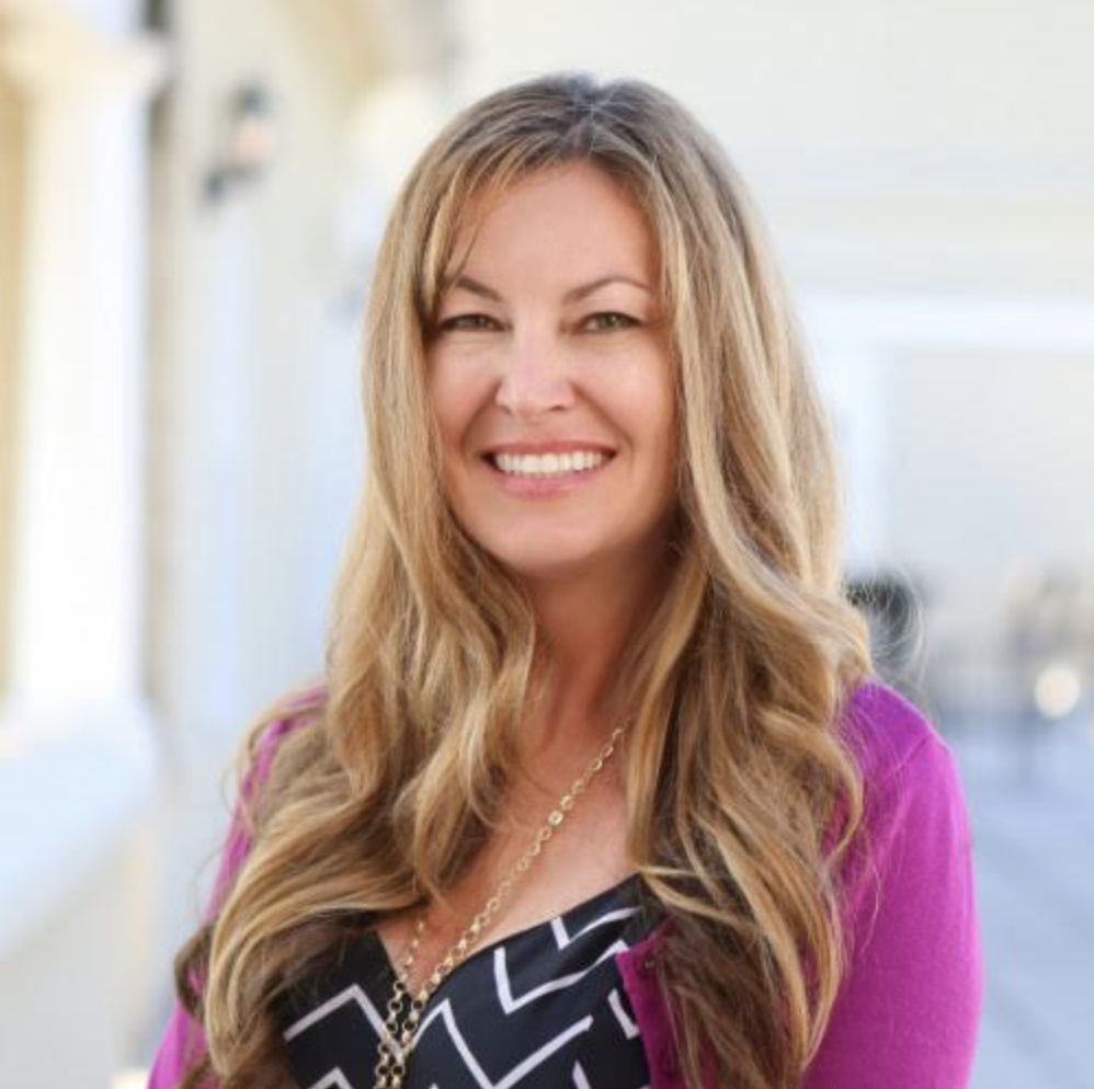 Headshot of a woman in a pink jacket
