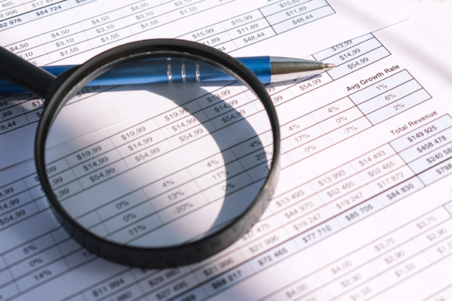 magnifying glass zooming in on text on a sheet of paper