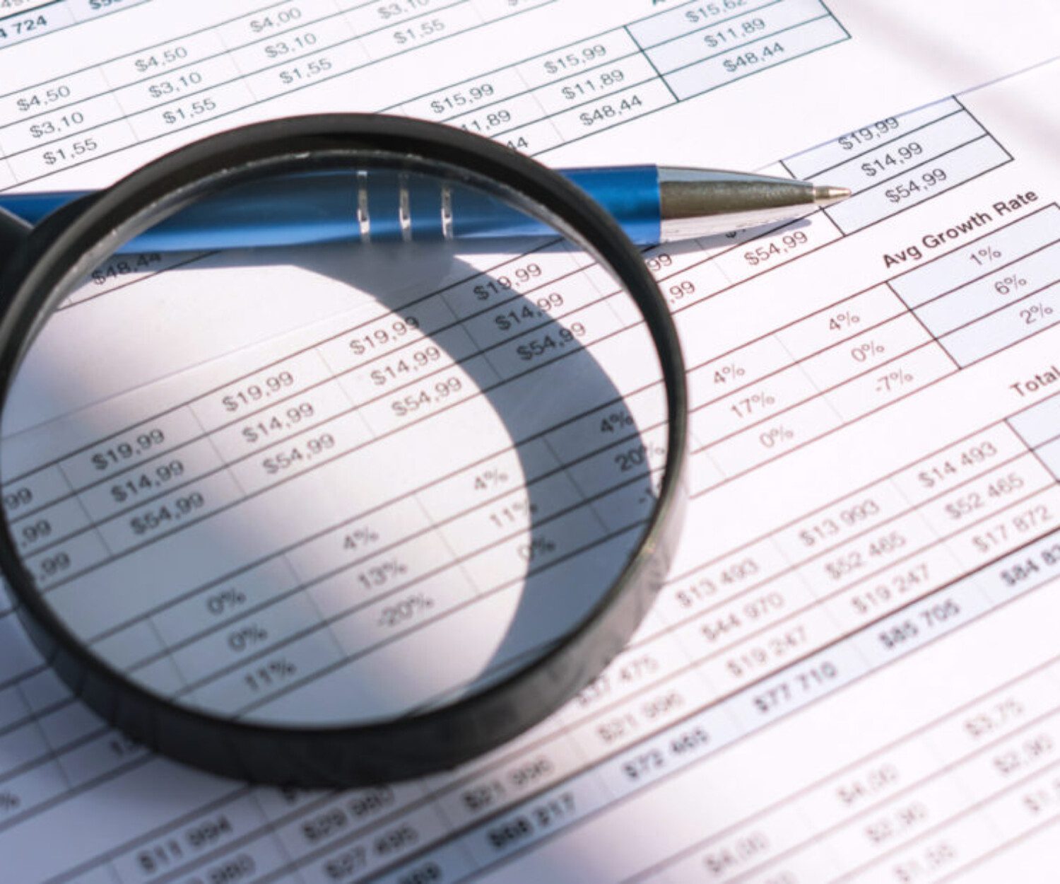 magnifying glass zooming in on text on a sheet of paper
