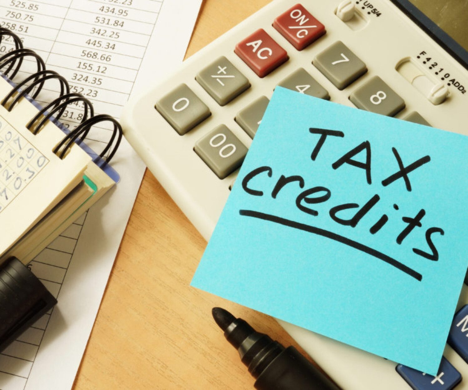 blue sticky note with "Tax credits" written