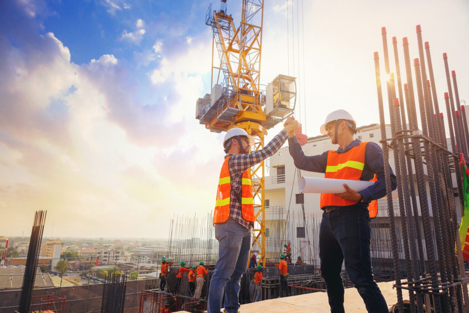 two construction workers giving each other a high-five