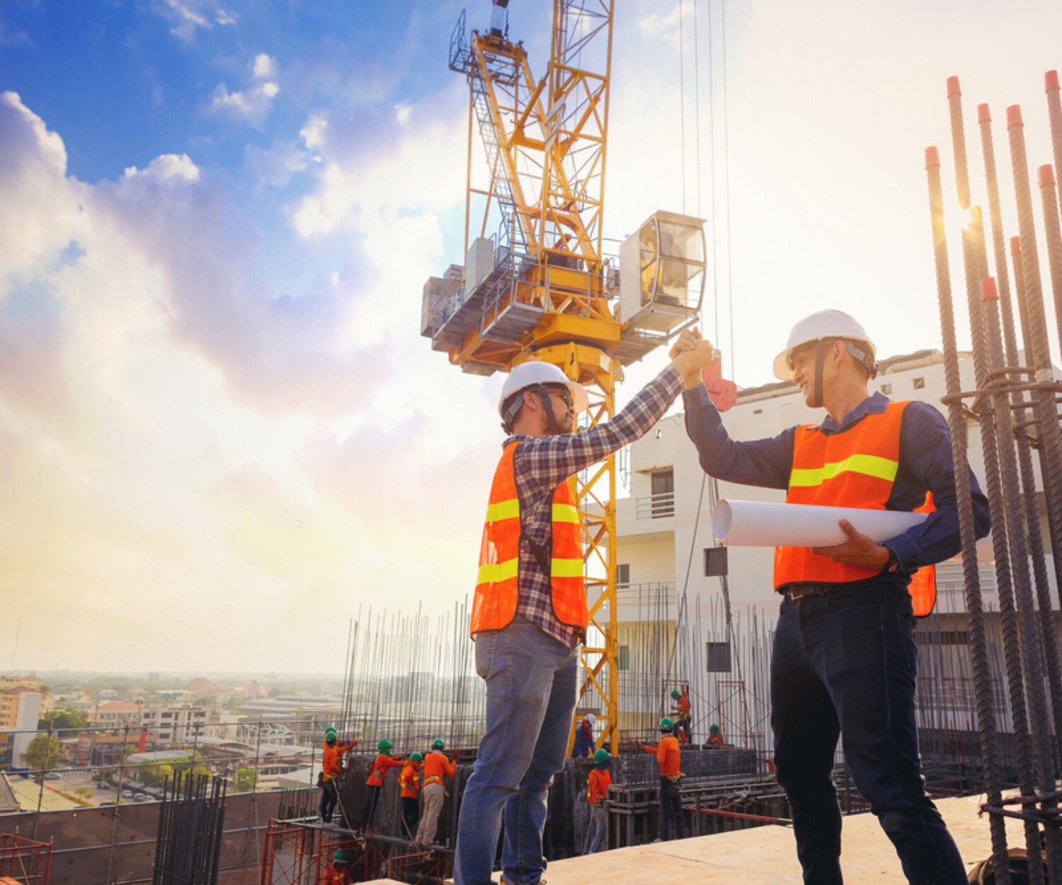 two construction workers giving each other a high-five