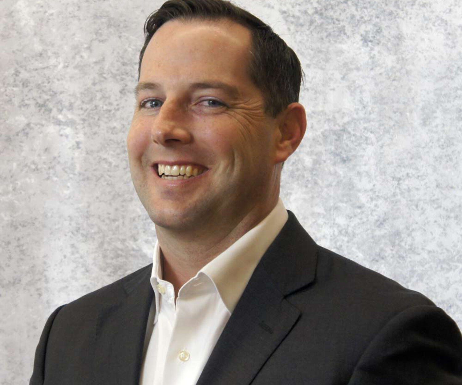 Headshot of a business man on a light grey background
