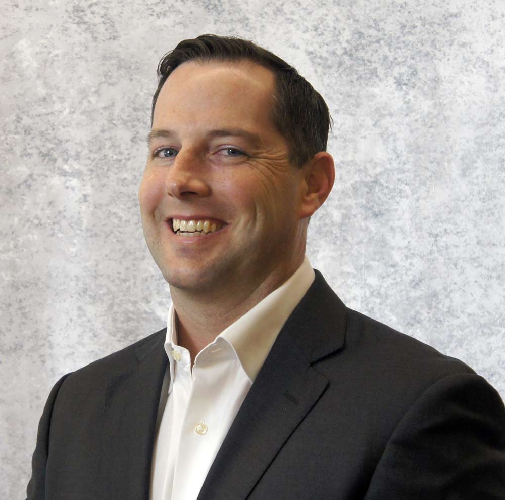 Headshot of a business man on a light grey background