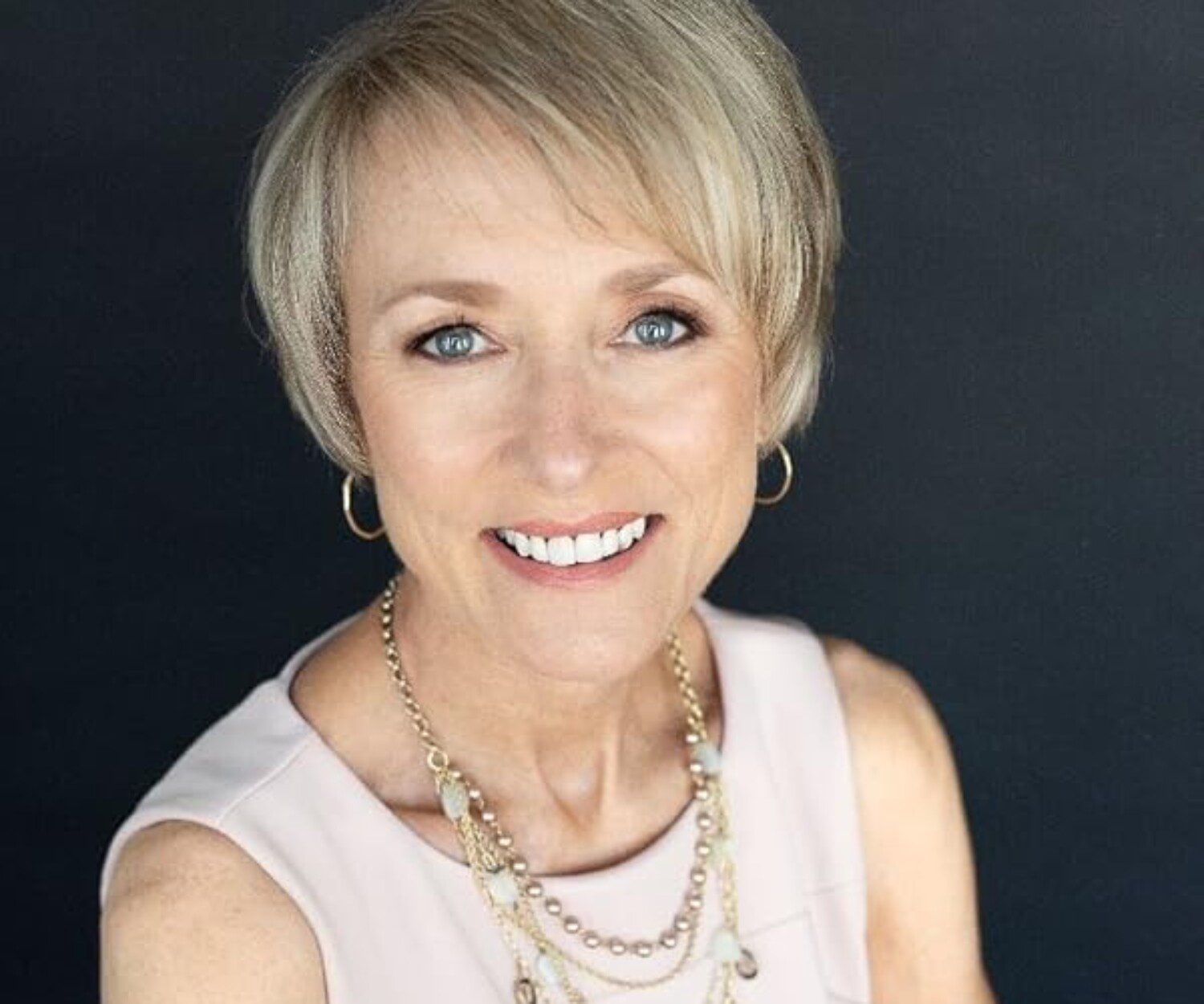 Headshot of a woman on a black background