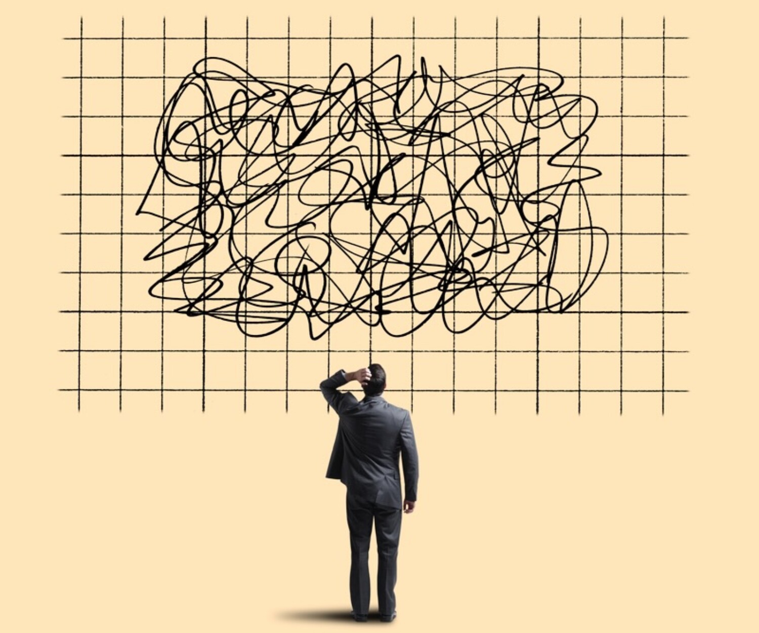 A businessman standing in front of a grid with squiggles on it representing confusion and uncertainty.