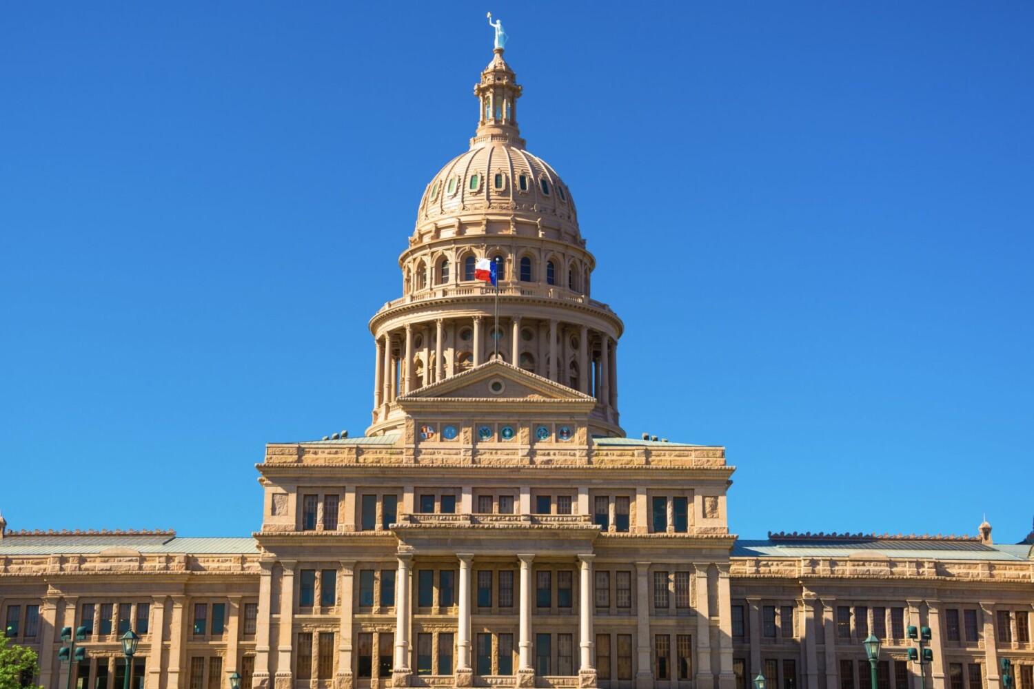 The Texas capitol building against a bright blue sky