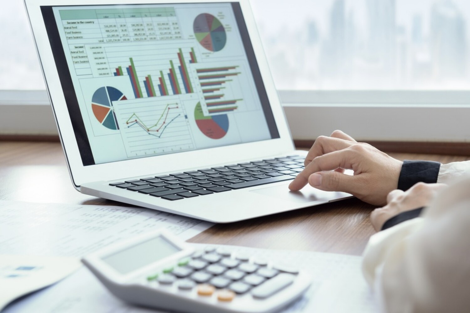 Accounting report spreadsheet. Business women using computer prepare business report for evaluation performance.