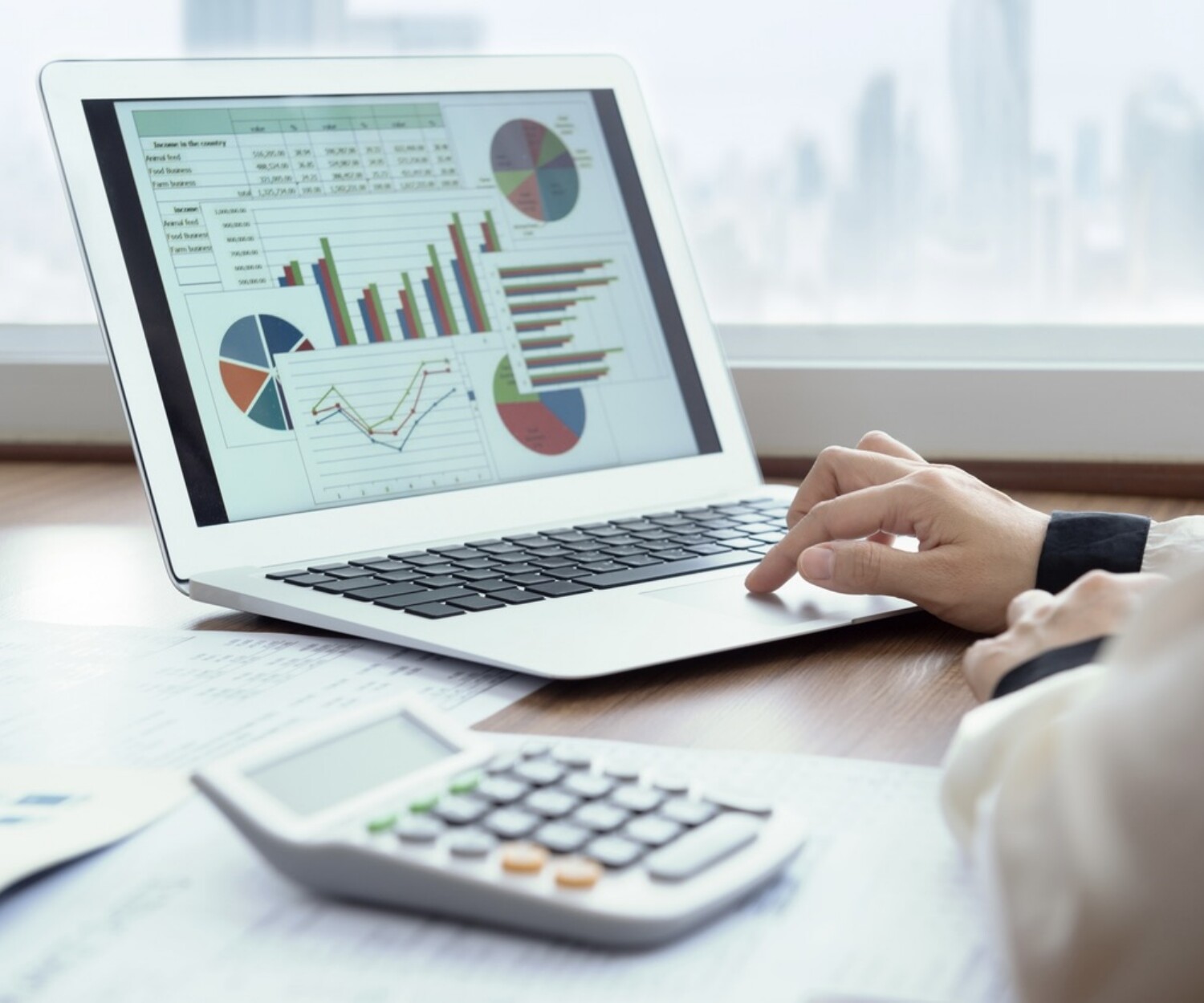 Accounting report spreadsheet. Business women using computer prepare business report for evaluation performance.