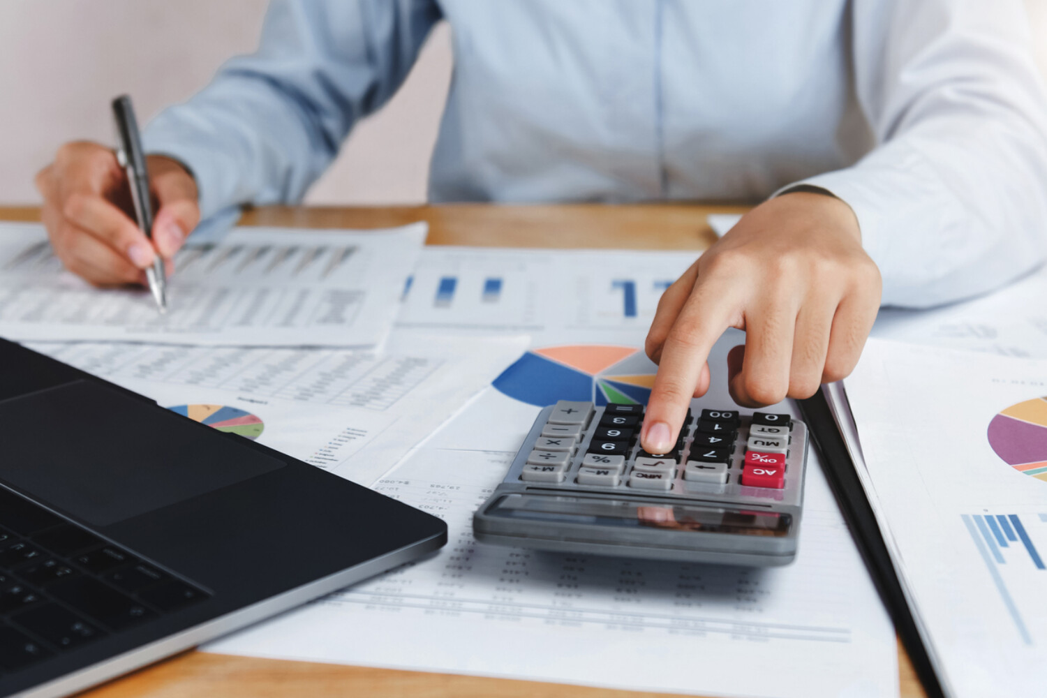 Government contractor reviewing financial records and calculating incurred cost submission for DCAA compliance.